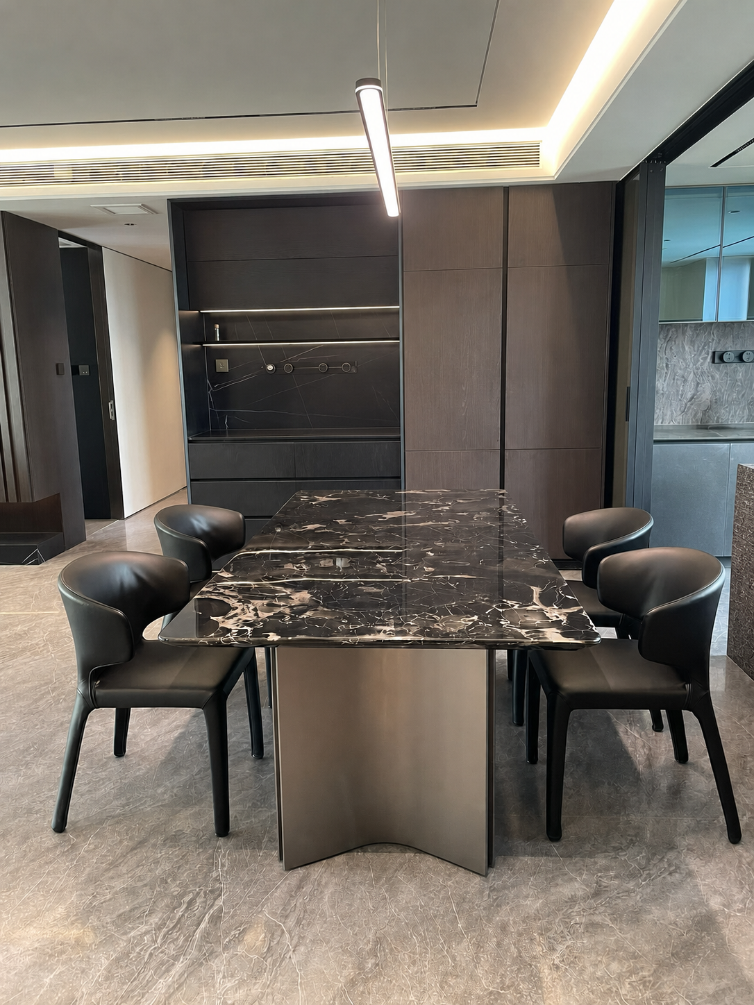 custom black marble dining table and chairs in high-end apartment