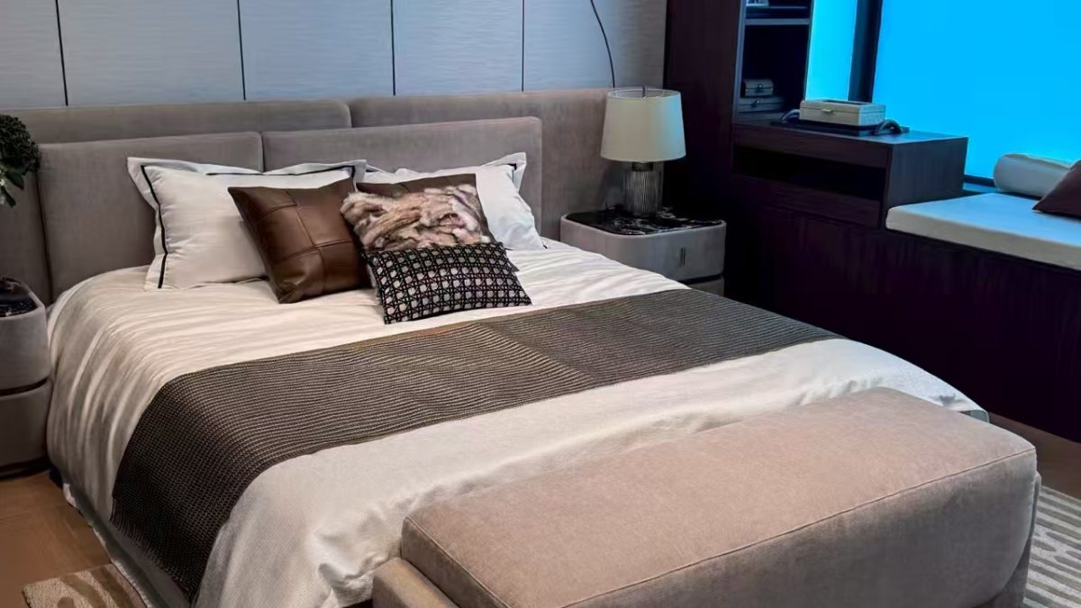 Modern villa bedroom with upholstered bed and custom wall panels