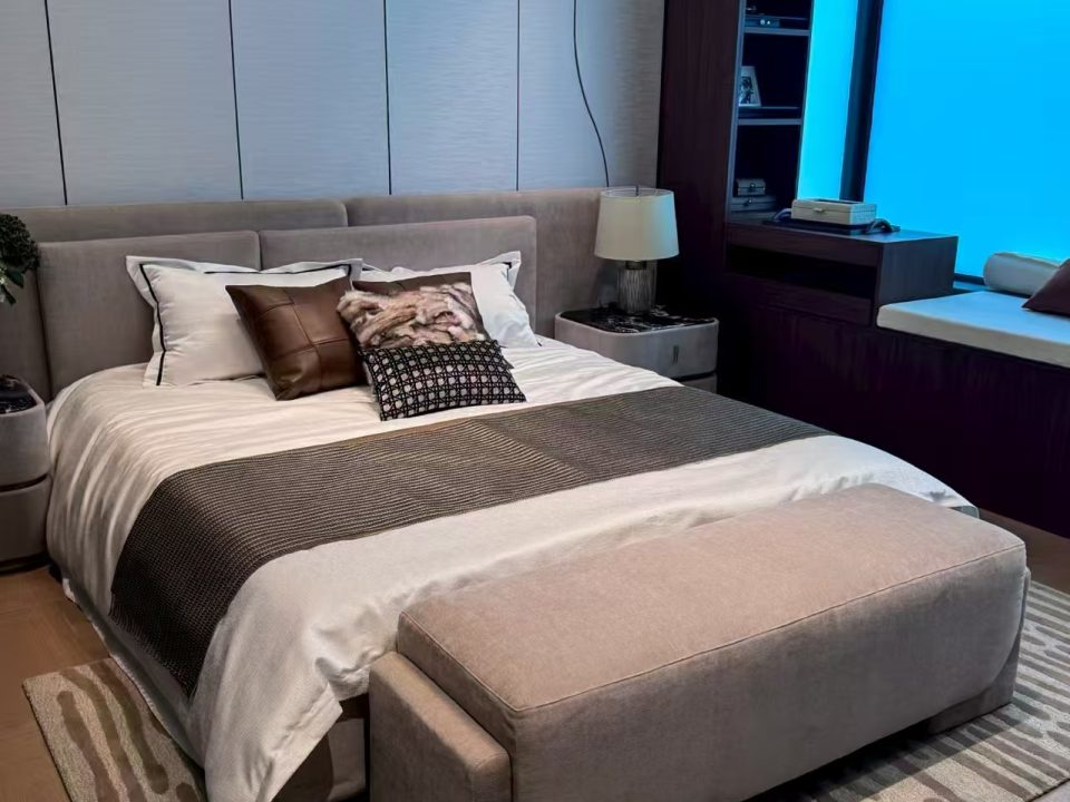 Modern villa bedroom with upholstered bed and custom wall panels