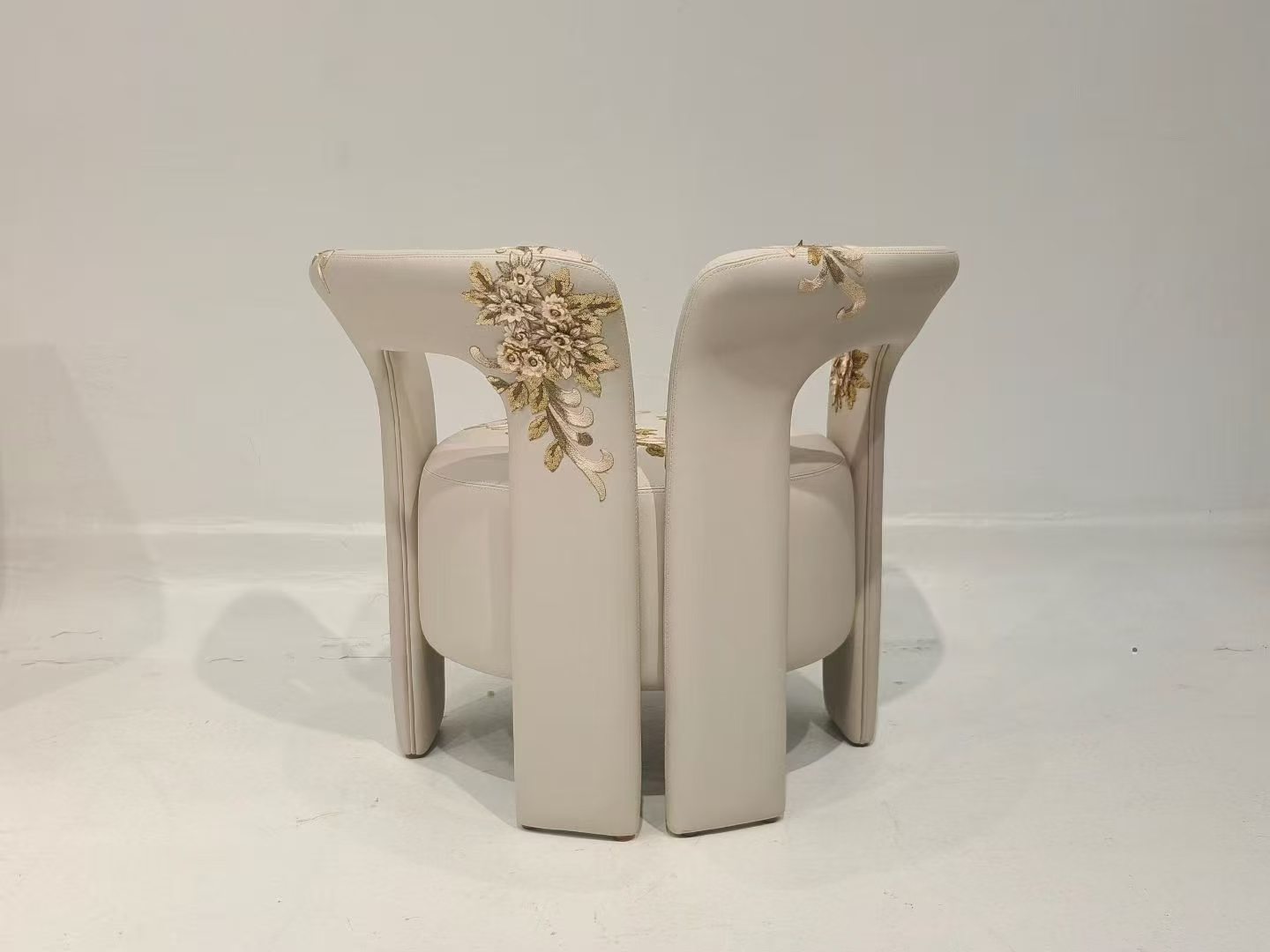 Custom upholstered armchair with floral embroidery detail