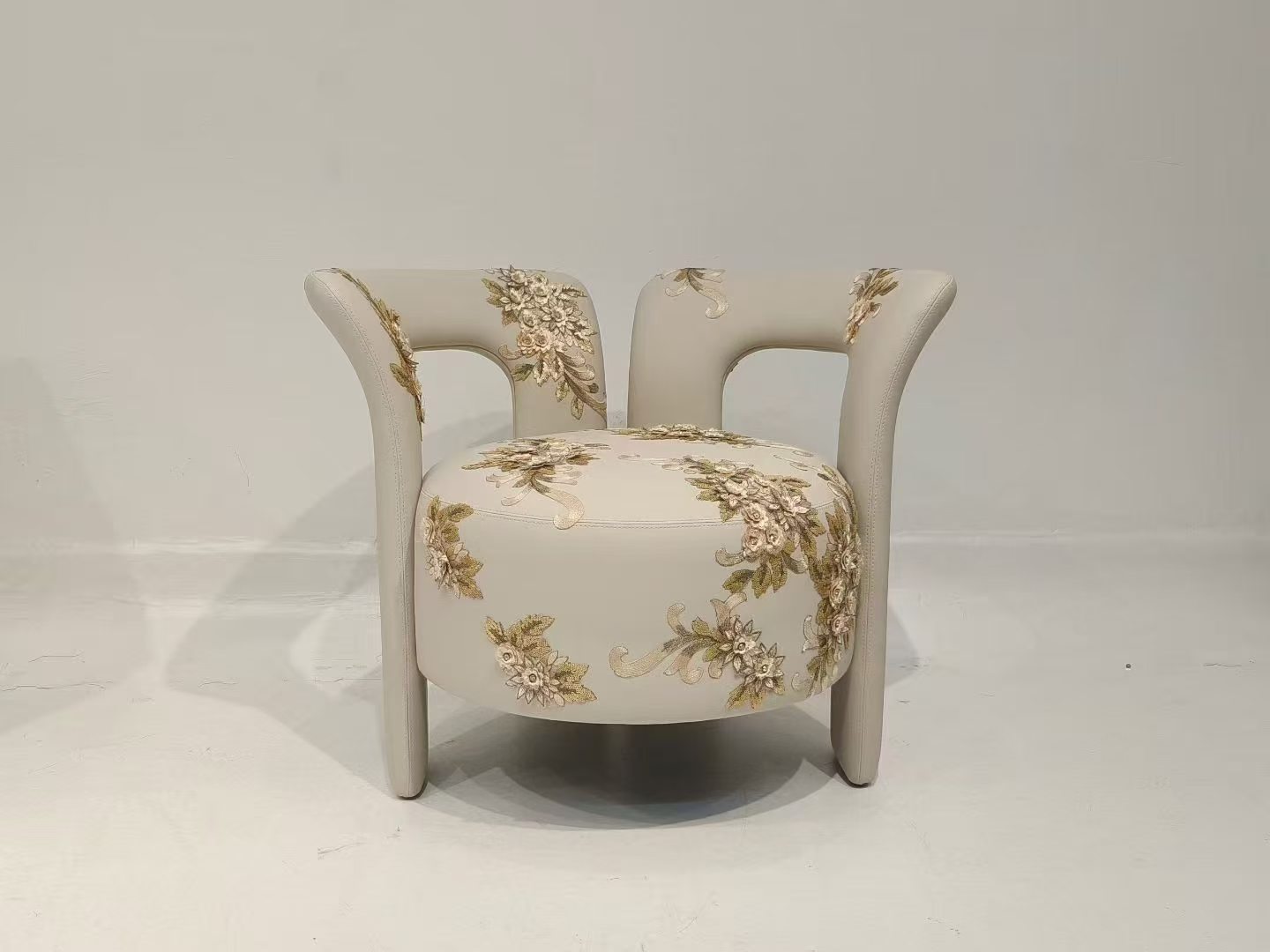 Custom upholstered armchair with detailed floral embroidery